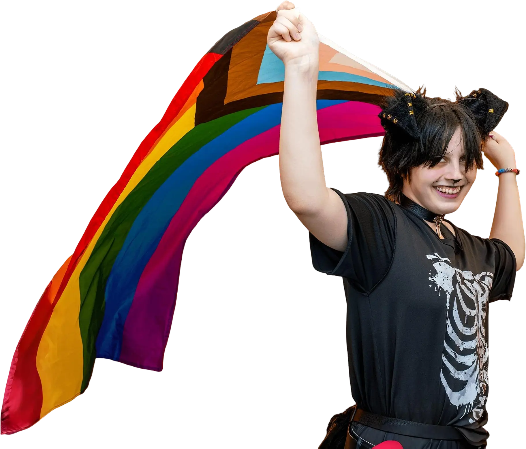 Person smiling and carrying a rainbow flag